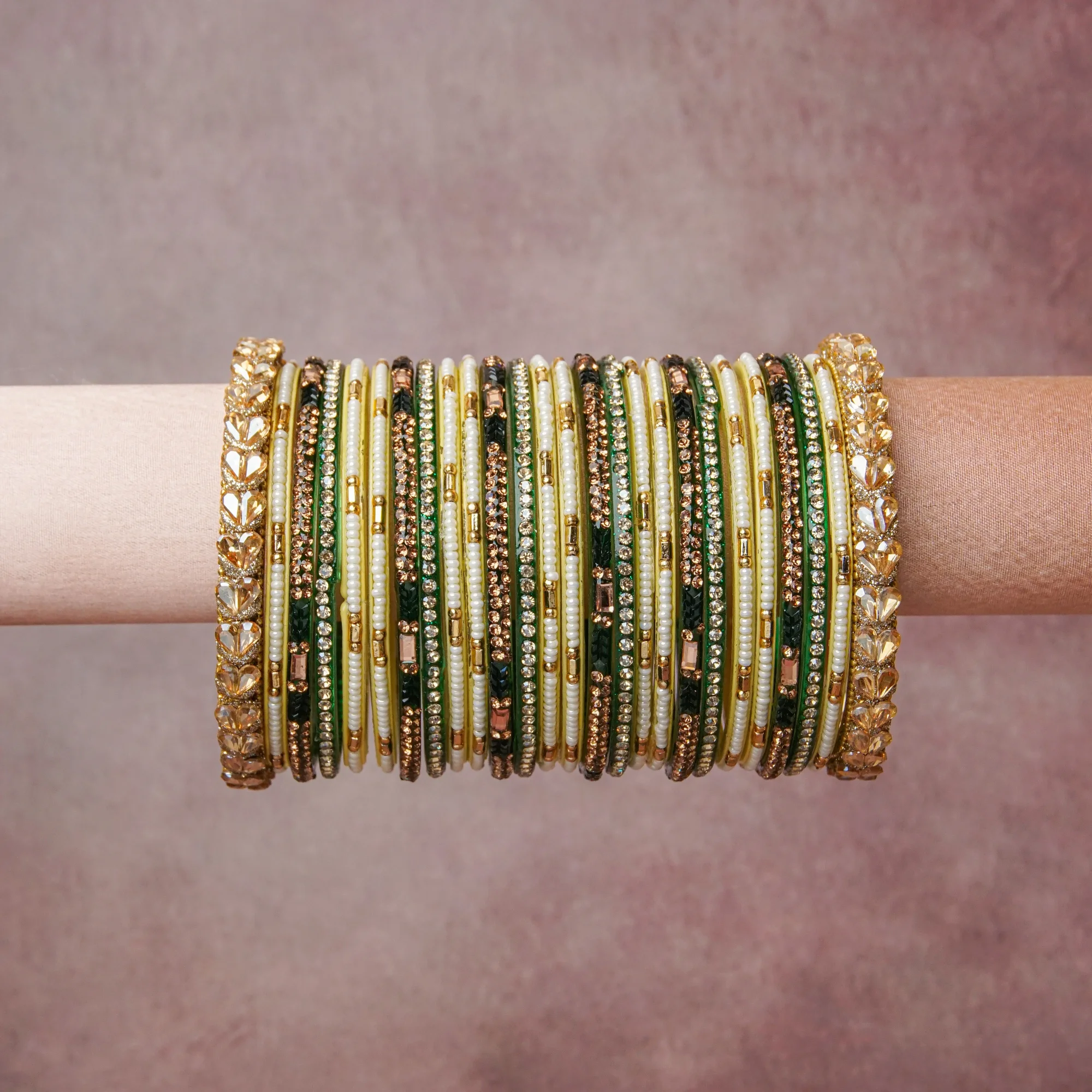 A grounding Green forms the heart of the set, while touches of Gold, Champagne, Ivory add charm.

A thoughtful composition of Metal Alloy, Lacquered Glass, Rhinestones, Faux Pearls, designed to feel complete without being heavy.
Each element layers seamlessly, creating a look that is refined, wearable and quietly striking.